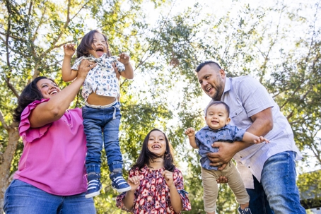 Family with a special needs child plays in the park on a sunny day