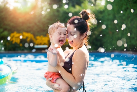mother and child playing in the pool
