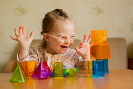 child with special needs playing with blocks