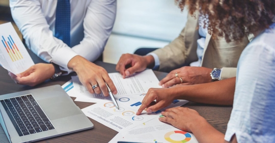 Couple talking with a financial advisor about their child's special needs trust fund management.