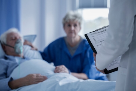 elderly couple in a hospital with a doctor
